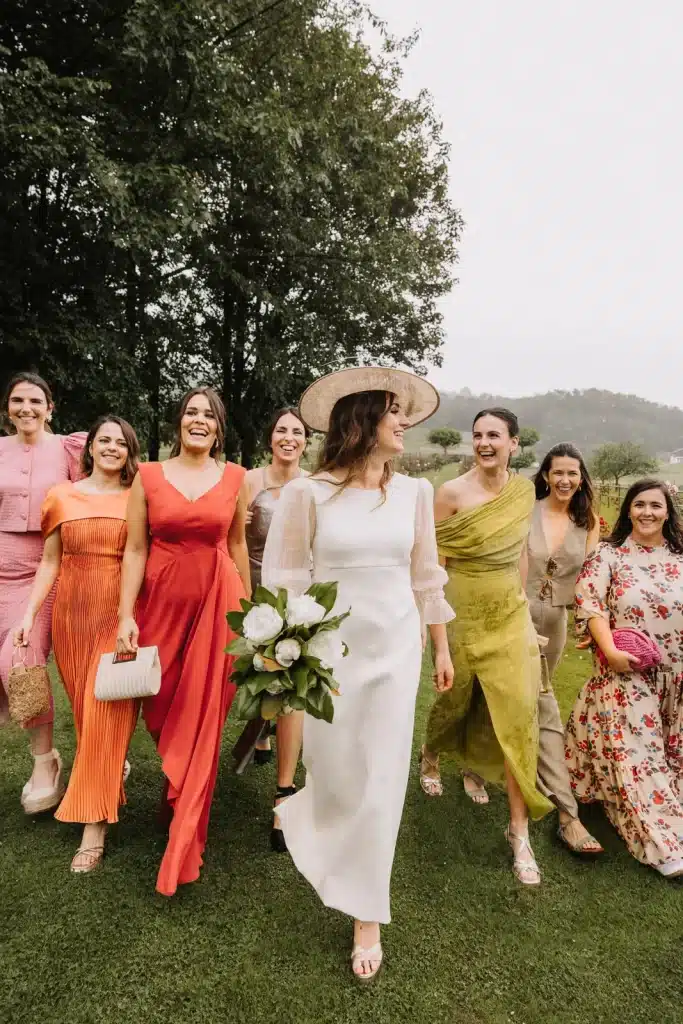 Bridesmaids in colourful dresses at outdoor wedding in France