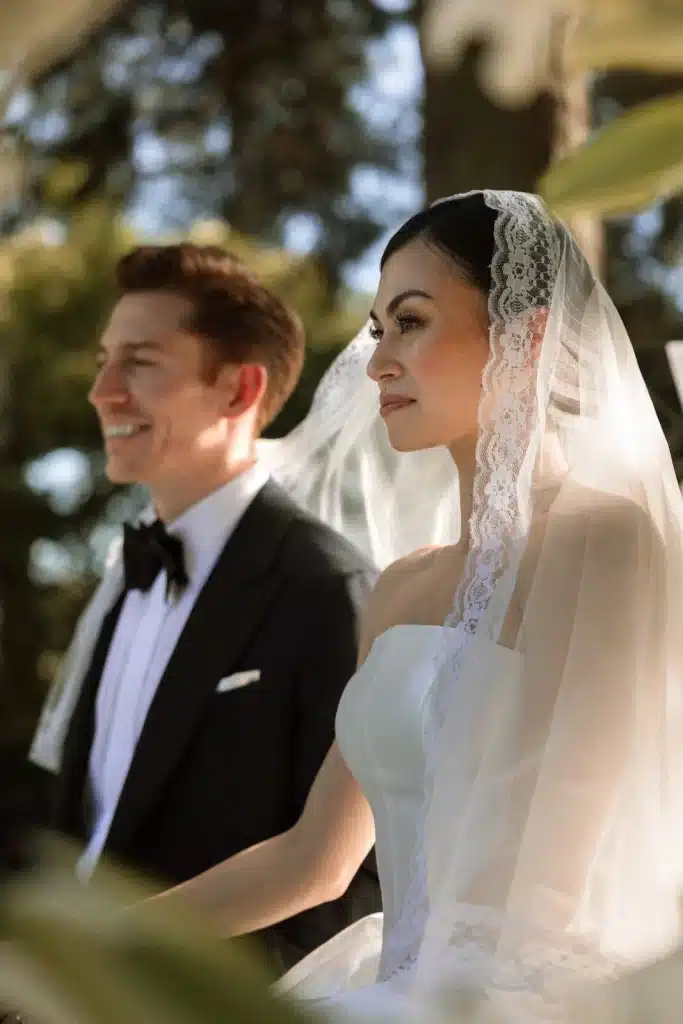 Groom smiling beside bride during luxury wedding in Italy
