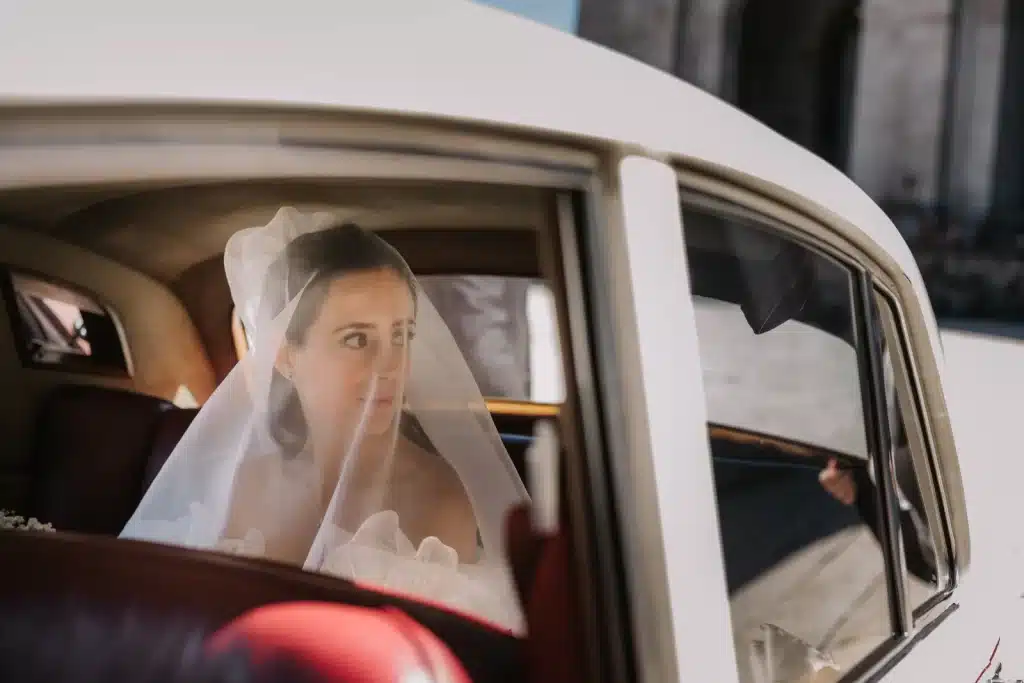 Bride in classic car during wedding celebration in Italy