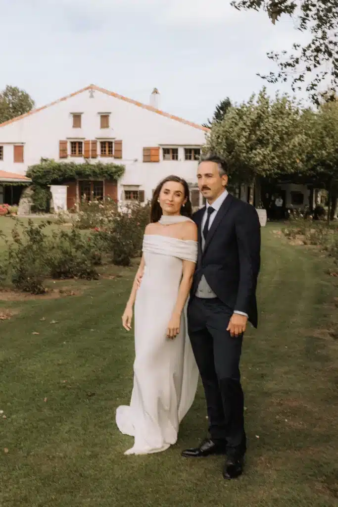 Standing couple portrait outside countryside estate during wedding in France