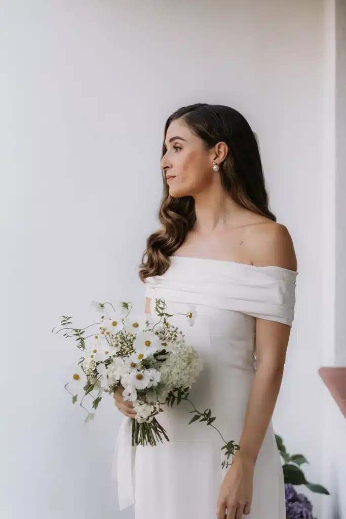 Modern bride portrait with off-shoulder gown at wedding in Greece