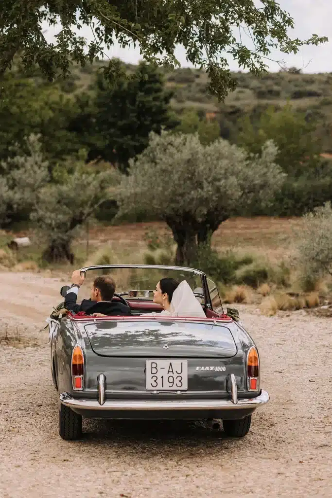 Classic convertible arrival at countryside wedding in Italy