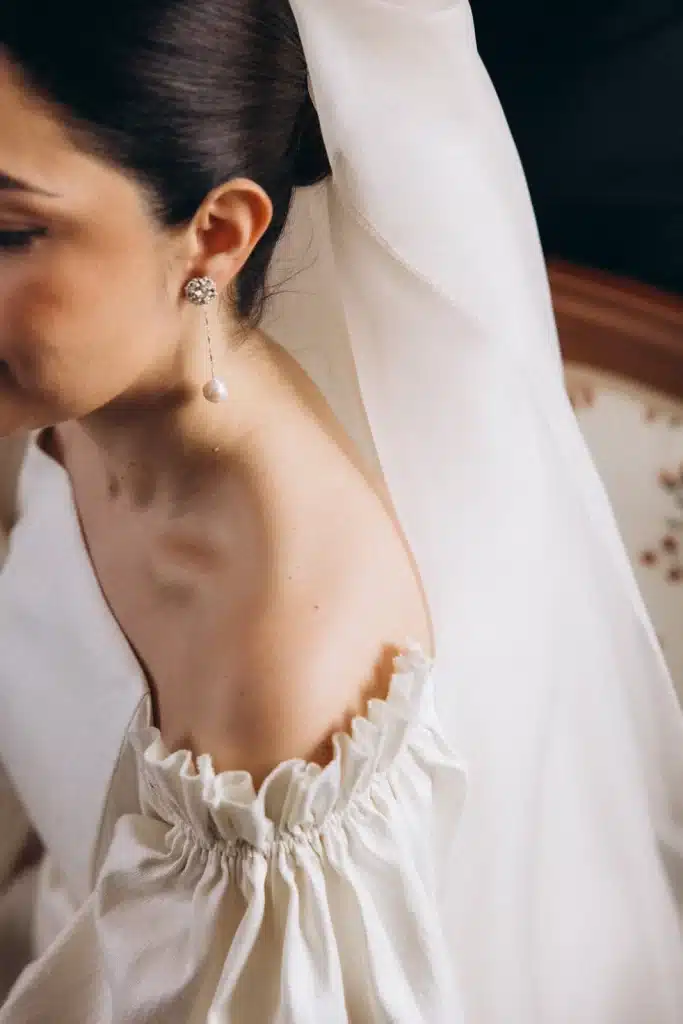 Bride adjusting veil before ceremony in Spain