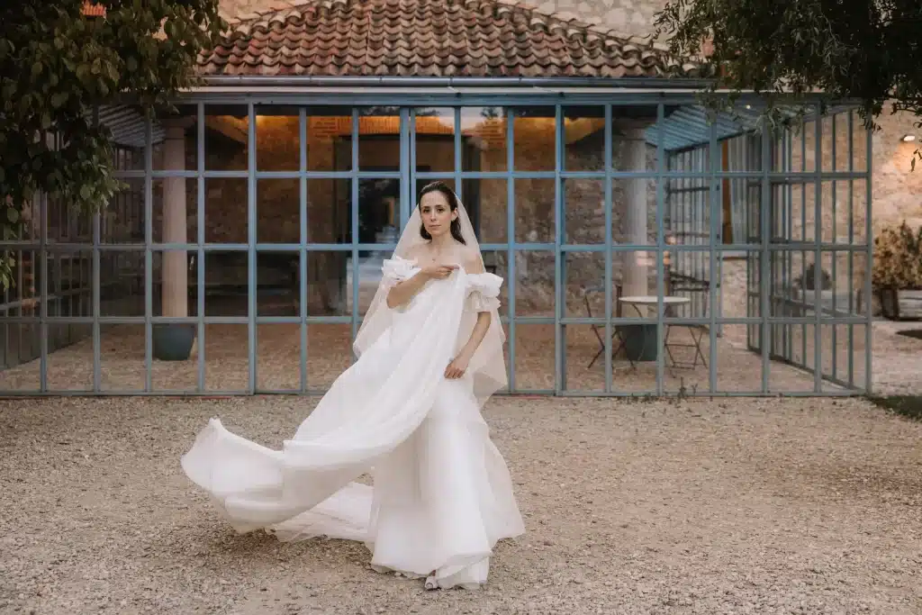 Bride walking through courtyard in Greece