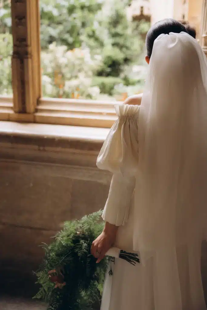 Bride by window in historic Tuscan estate