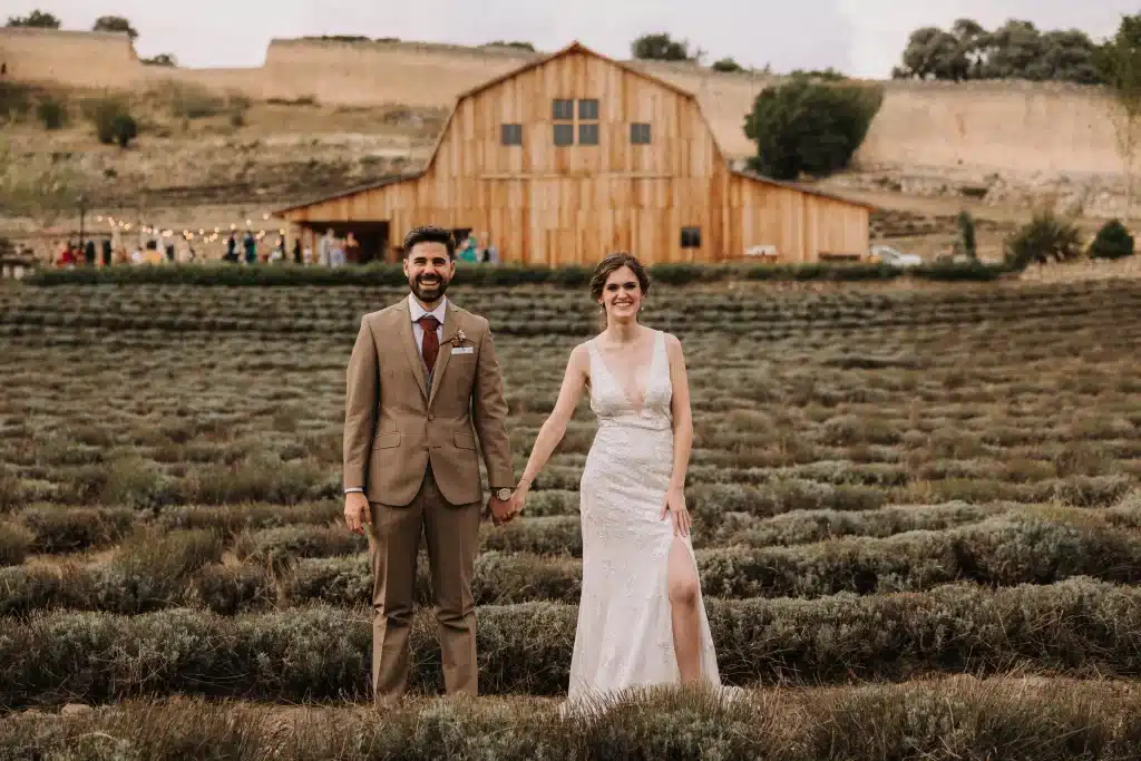 Bride and groom walking through Portugal hills at sunset