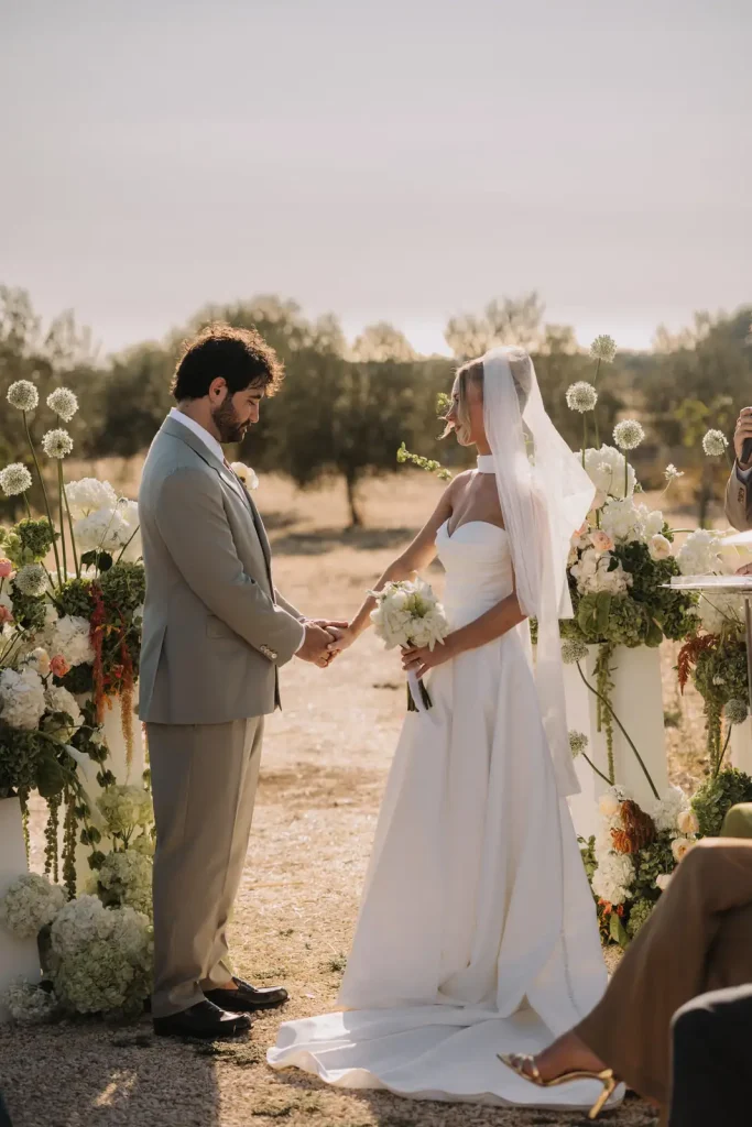 Outdoor wedding ceremony surrounded by olive trees at Villa Càrcara in Sicily