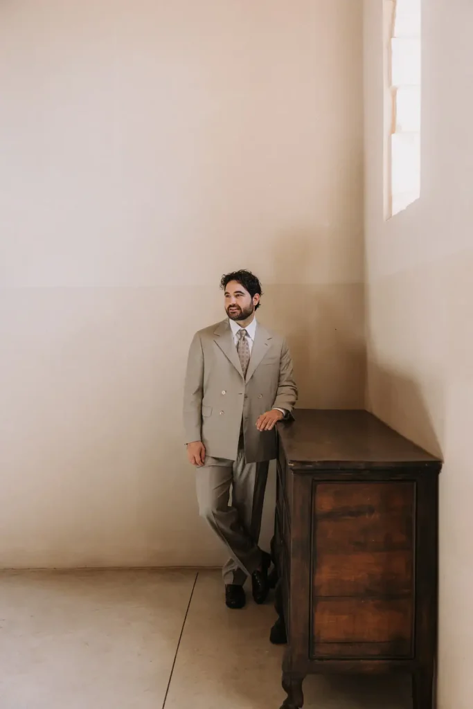 Groom posing at Villa Càrcara during a Sicily destination wedding